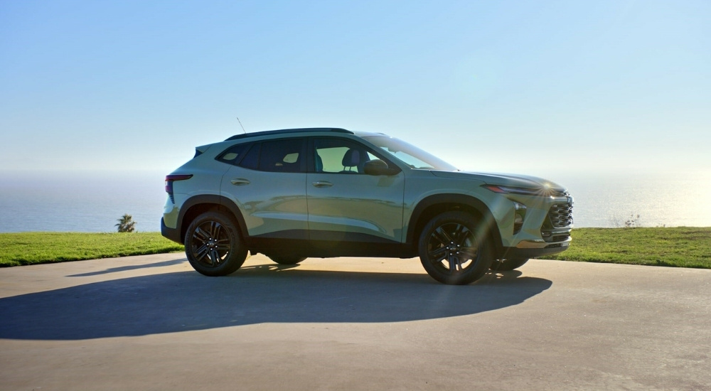 Green 2024 Chevy Trax ACTIV parked near a lake