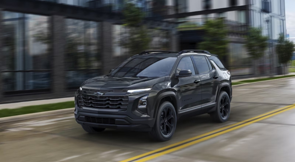 Black 2025 Chevy Equinox Midnight Edition driving on a city street