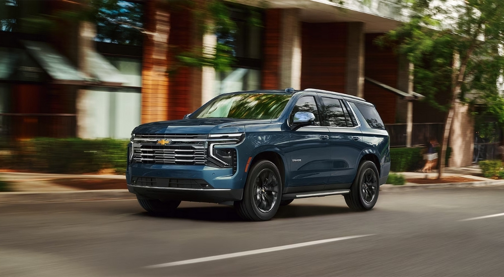 Blue 2026 Chevy Tahoe driving on a city street