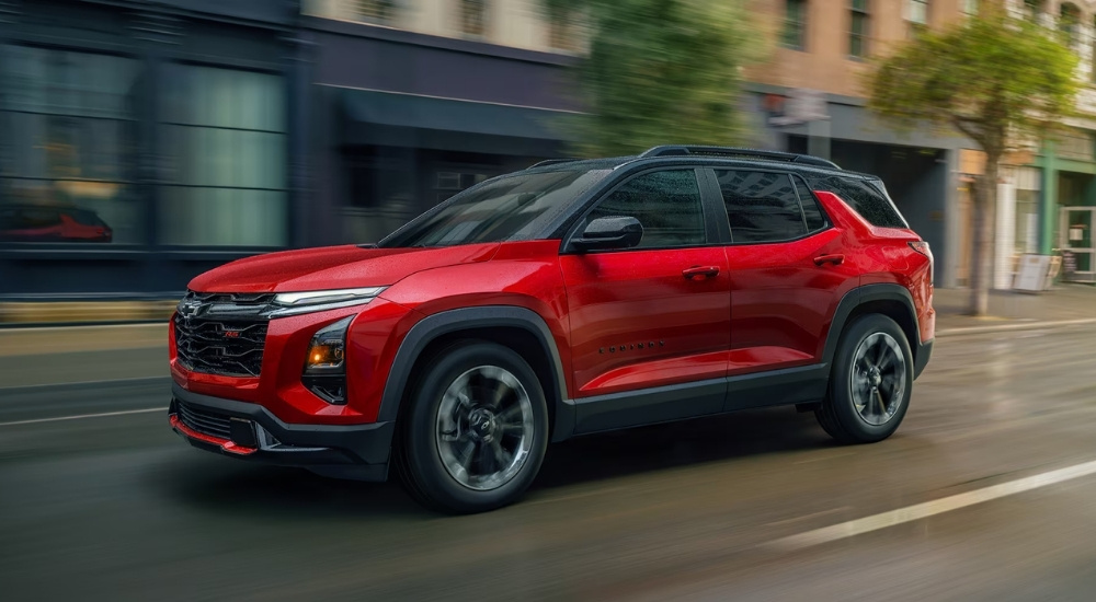 Red 2026 Chevy Equinox RS driving in a city