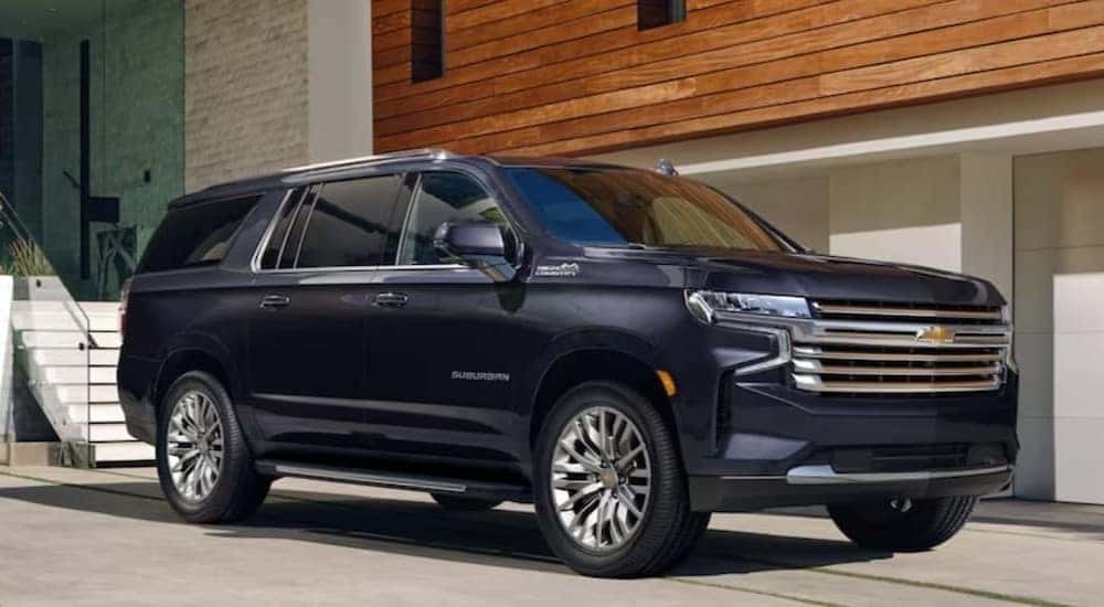 A blue 2023 Chevy Suburban High Country is shown parked near used SUVs for sale