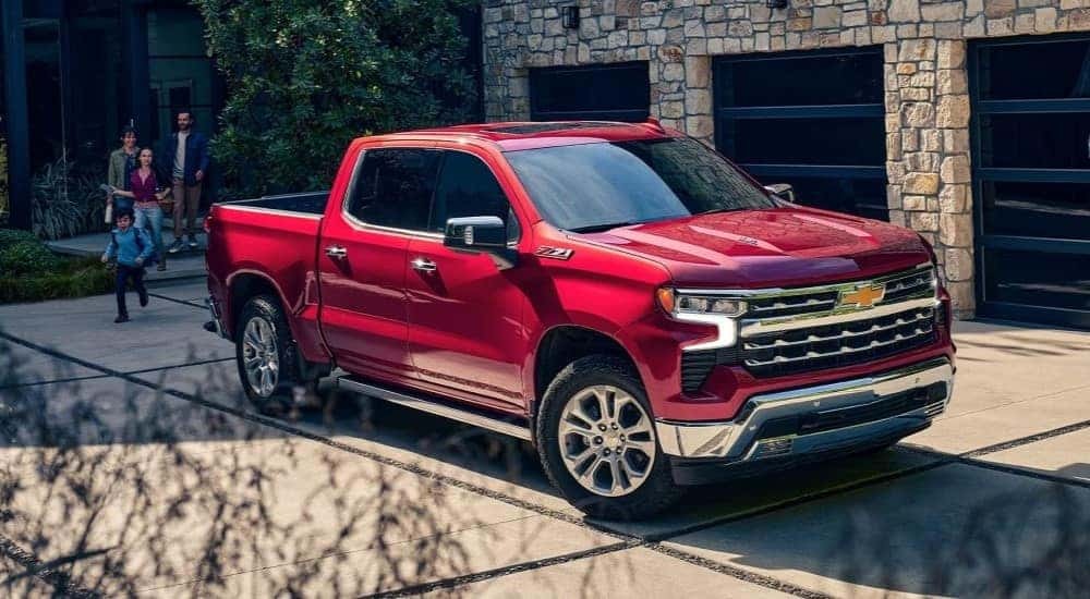 A red 2024 Chevy Silverado 1500 Z71 is shown parked after visiting a truck dealer.