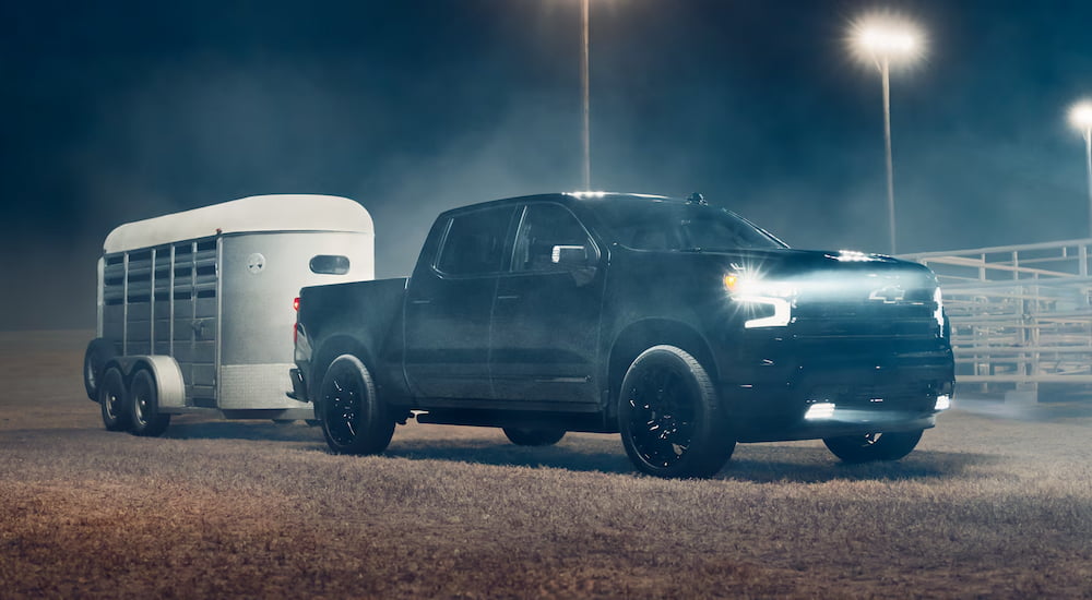 Black 2026 Chevy Silverado 1500 towing a cart.