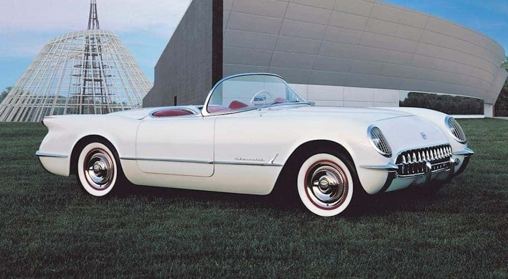 A white 1953 Chevy Corvette is shown parked in the grass after visiting Bessemer Chevy dealer.