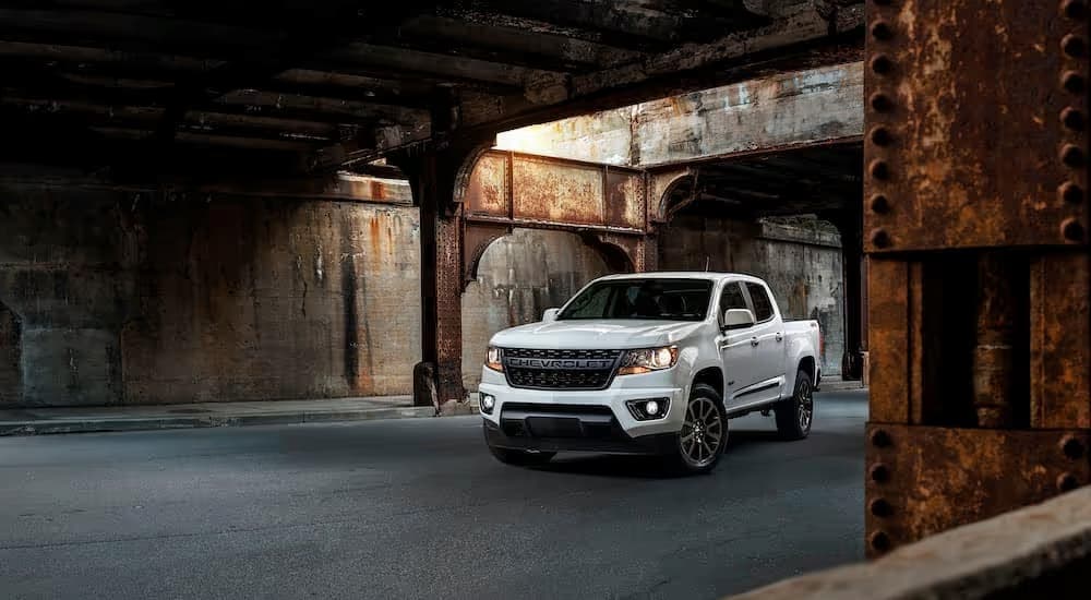 A white 2019 Chevy Colorado RST is shown parked near rusty supports after leaving a used Chevy truck dealer near you.