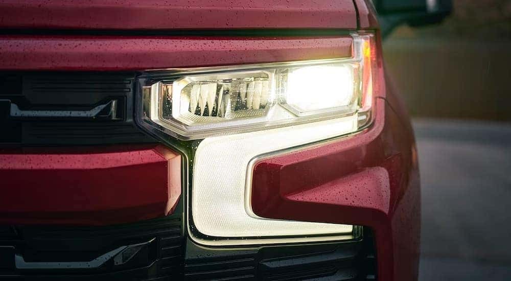 Headlight of a red 2026 Chevy Silverado 1500 RST