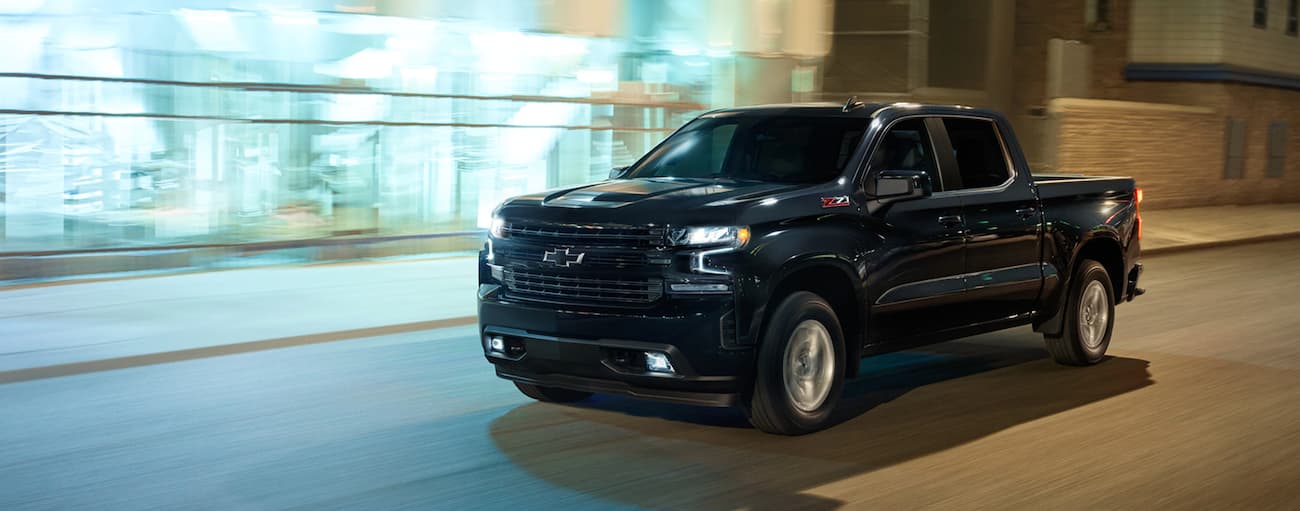 Black 2020 Chevy Silverado 1500 Z71 driving down a city street.