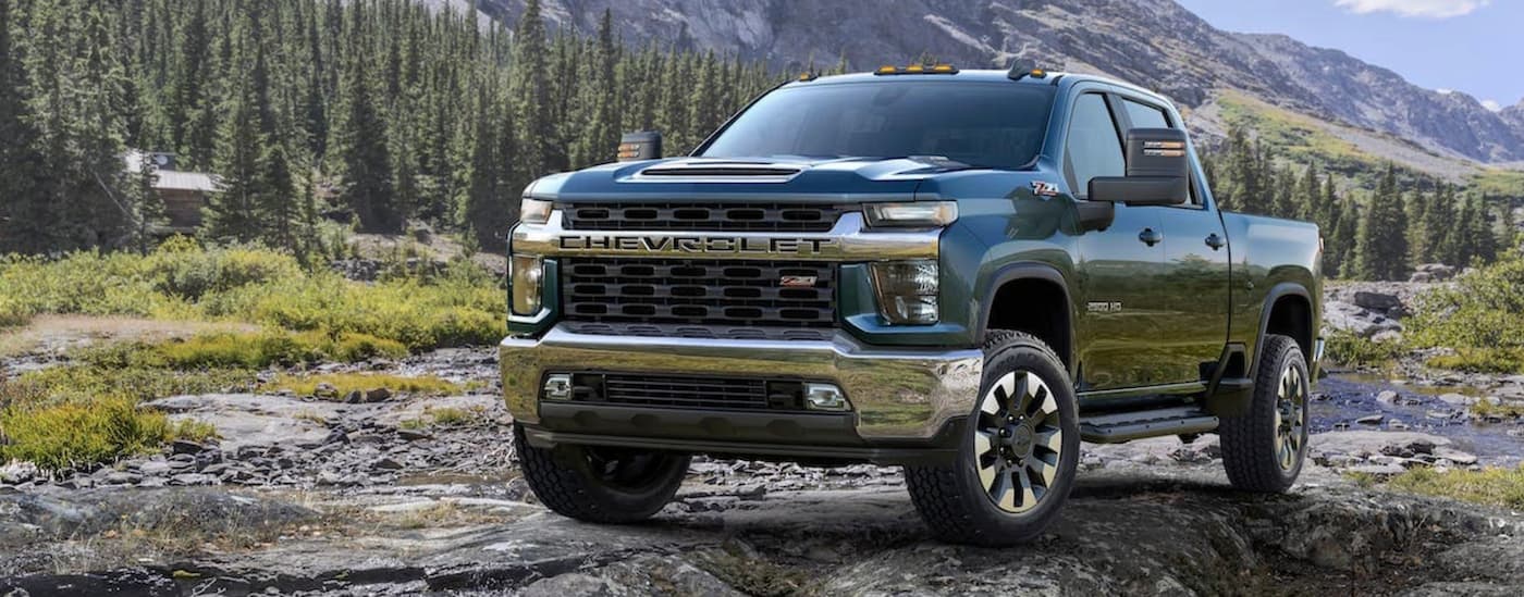 Blue 2020 Chevy Silverado 2500 HD Z71 parked off-road on a rocky hill.
