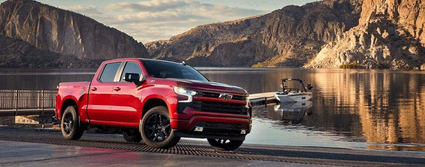 A red 2024 Chevy Silverado 1500 LTZ Z71 parked near a lake.