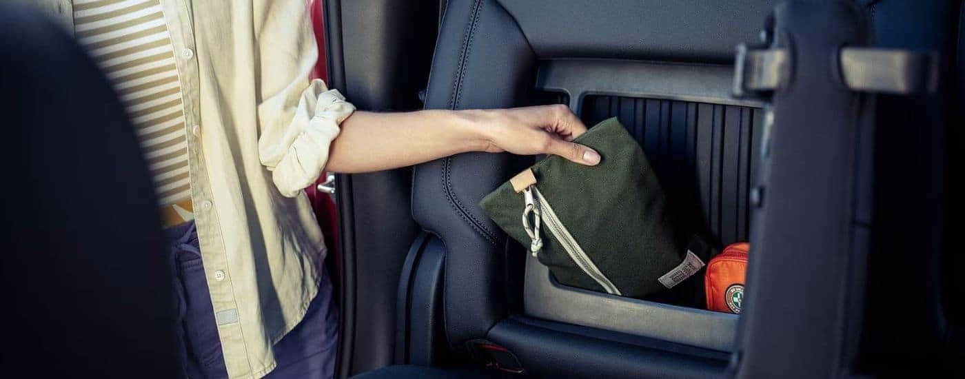 A storage compartment is shown in a 2024 Chevy Silverado 1500.