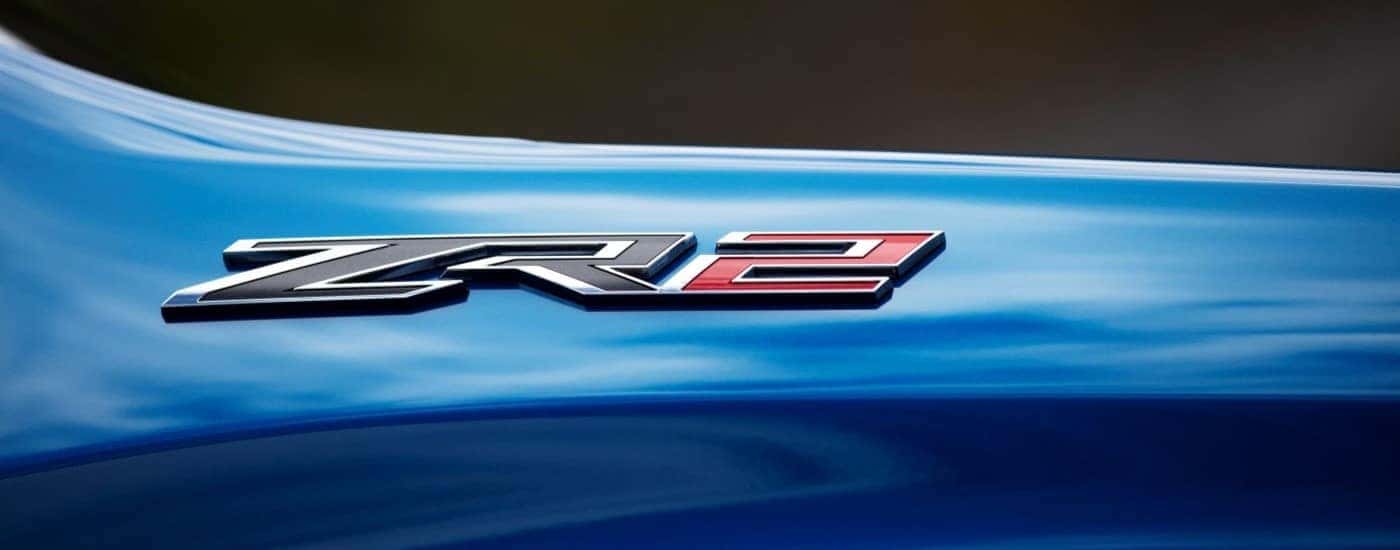 A close up shows the ZR2 badge on a blue 2024 Chevy Silverado ZR2.
