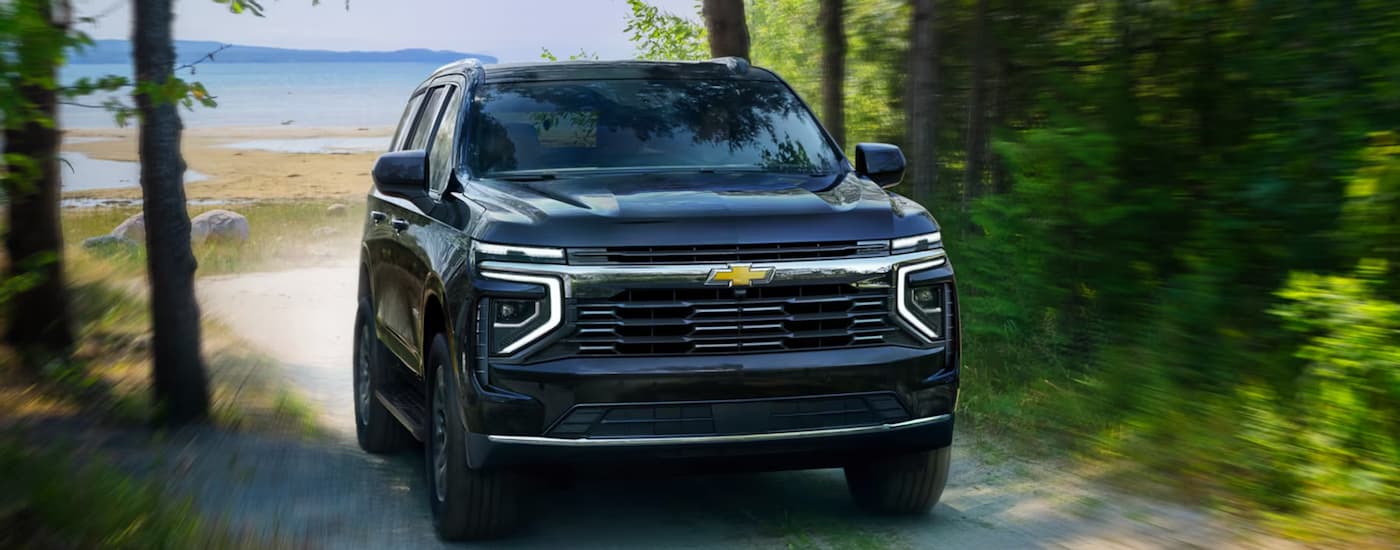 Dark blue 2026 Chevy Tahoe driving off-road.