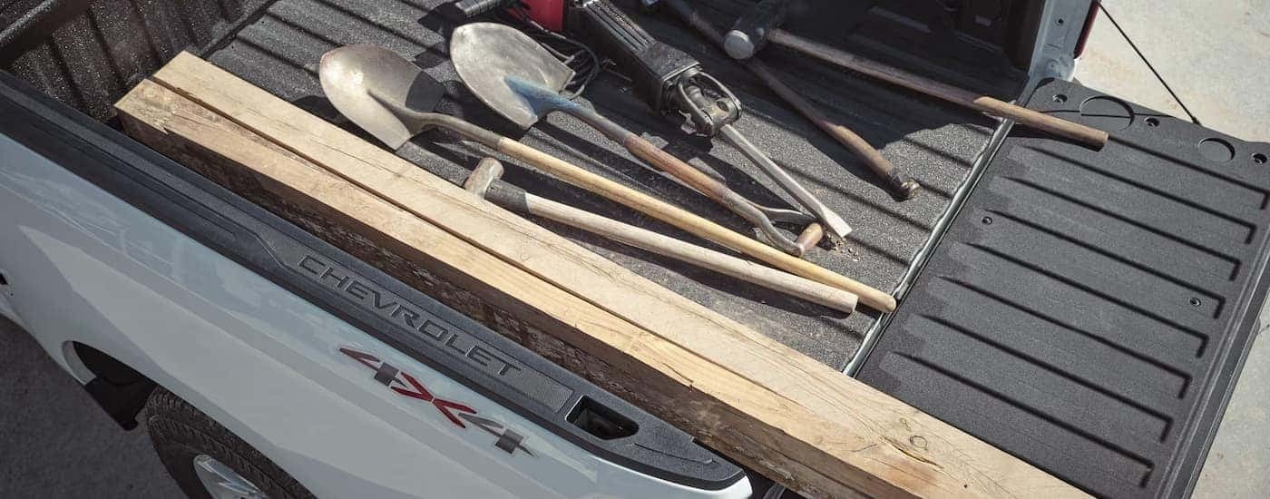 Tools in the bed of a white 2026 Chevy Silverado 1500