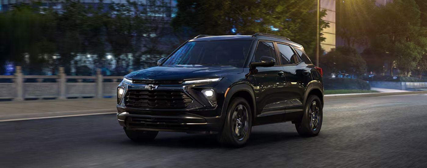 Black 2026 Chevy Trailblazer Midngiht Edition driving through the city at night.