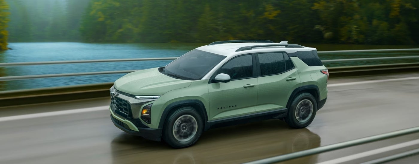 Green 2026 Chevy Equinox driving on a highway