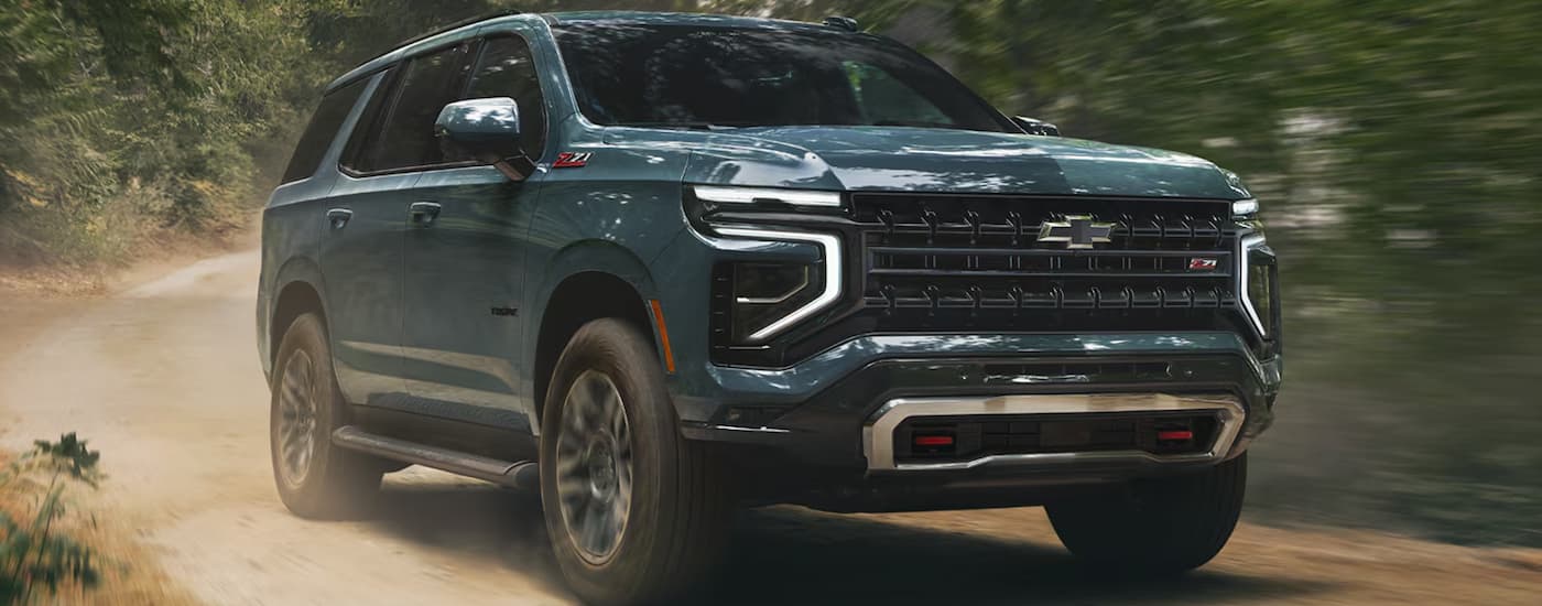 Green 2026 Chevy Tahoe driving off-road.