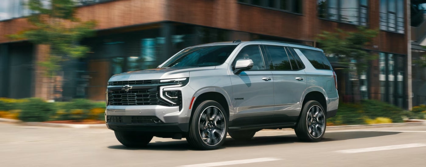 Silver 2026 Chevy Tahoe RST driving on a city street