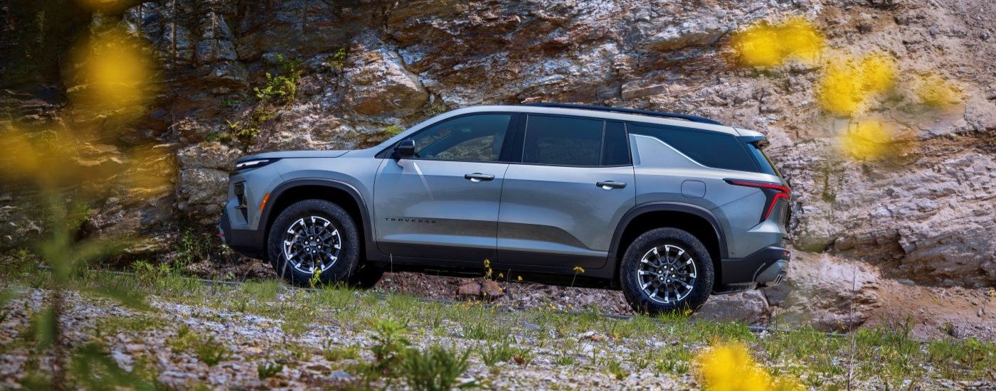 Silver 2026 Chevy Traverse driving uphill