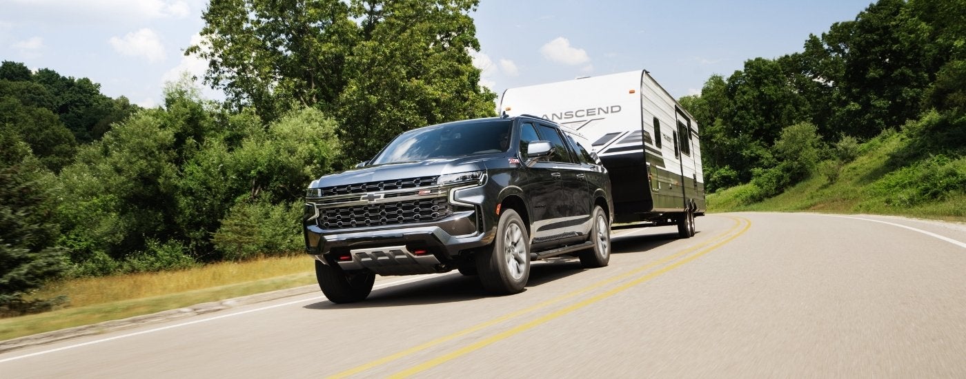 Grey 2023 Chevy Suburban Z71 driving to a Birmingham Chevy dealership