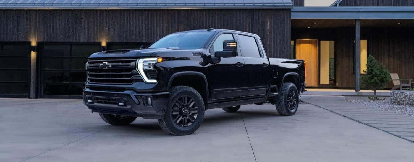 A black 2024 Chevy Silverado 2500 HD High Country is shown parked after visiting a Chevy Silverado for Sale Near Bessemer.