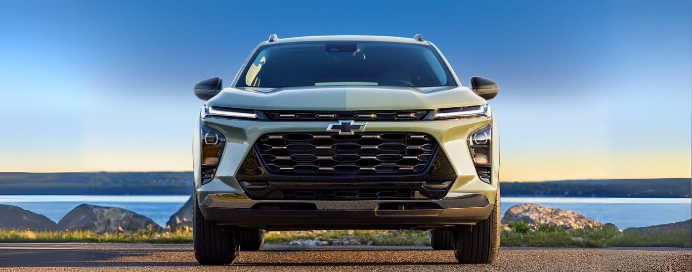 Green 2024 Chevy Trax ACTIV parked near a lake