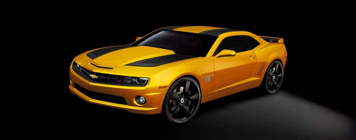 A yellow 2012 Chevy Camaro against a dark background.