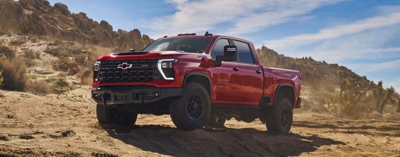 A red 2024 Chevy Silverado 2500 HD ZR2 Bison is shown from the front at an angle.