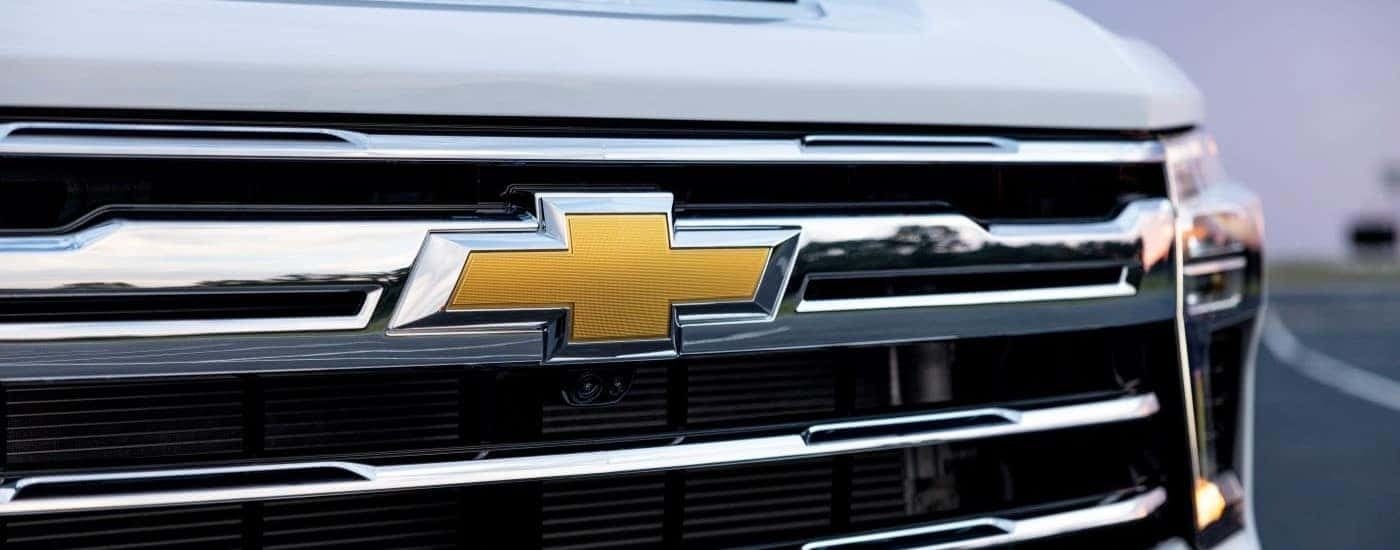 Close-up on the grille of a white 2024 Chevy Silverado 3500 HD LTZ.