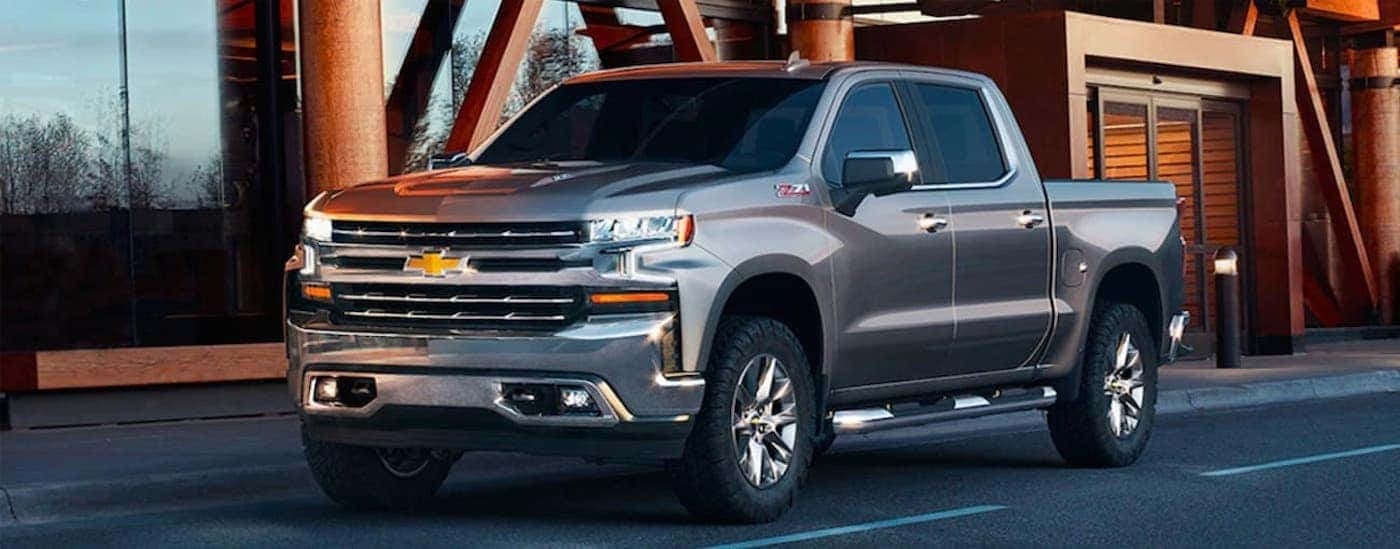 A grey 2019 Chevy Silverado 1500 Z71 parked by a building with used trucks for sale near me.