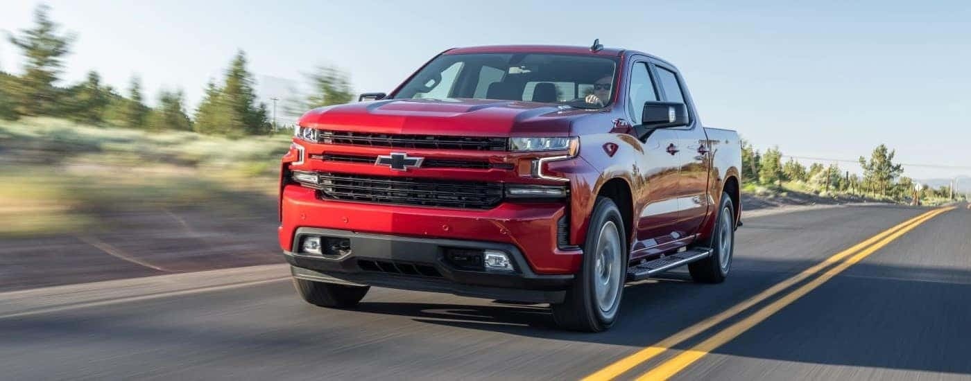 A red 2020 Chevy Silverado 1500 Z71 driving down a road.