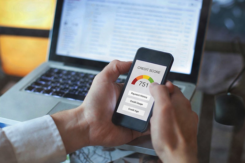 A person views a credit score on their smartphone screen